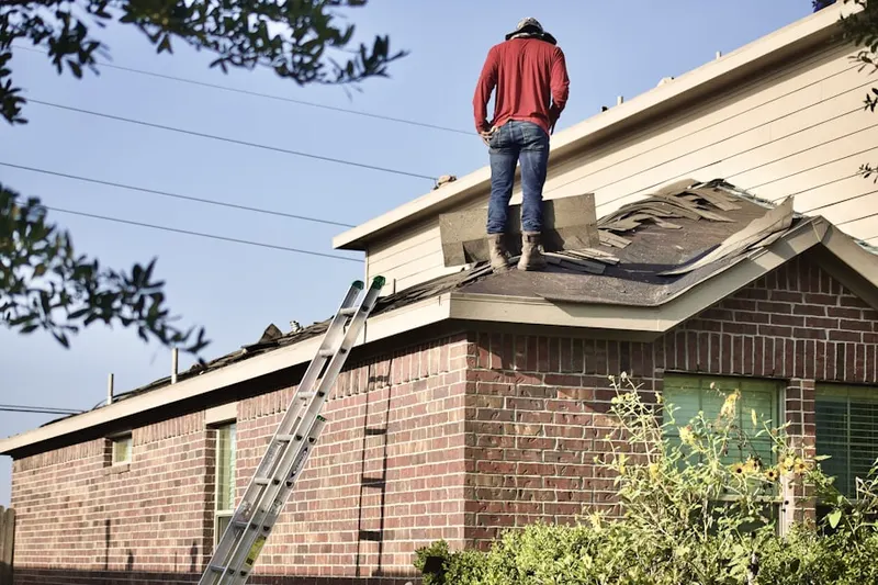Professional roofer working on a residential roof in Warner Center